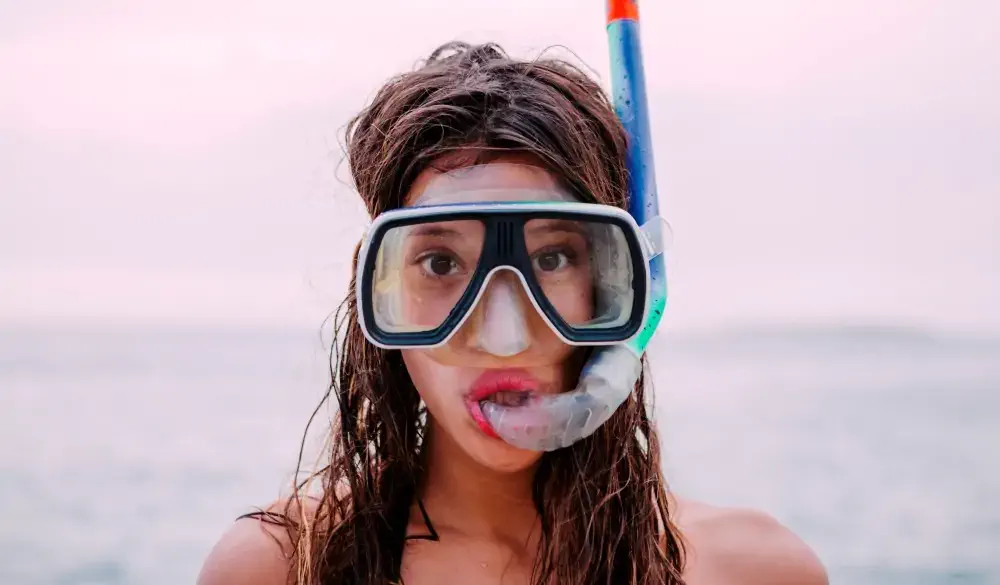 Young woman with diving goggles and snorkel