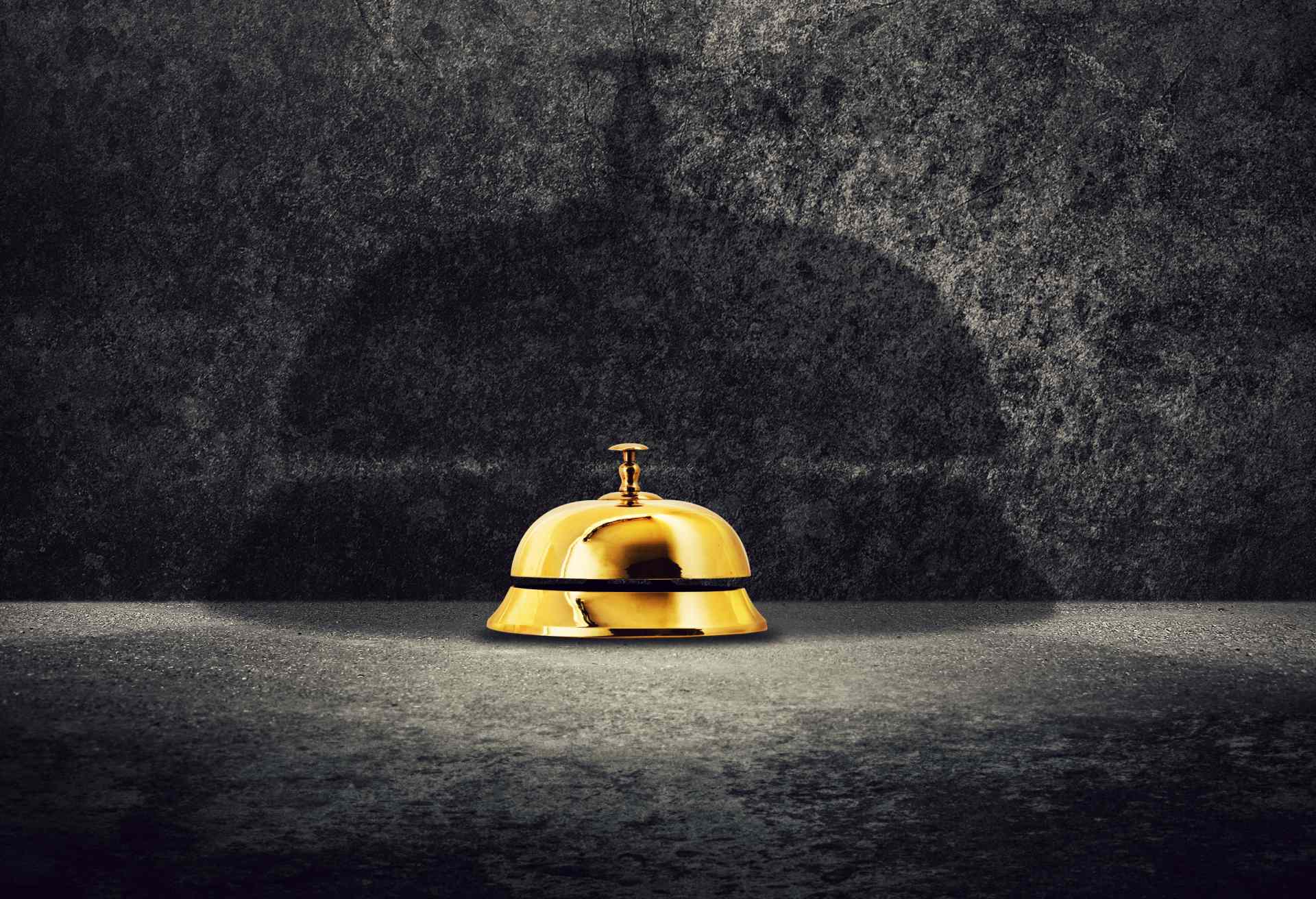 Brass hotel reception bell on ground
