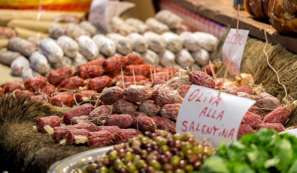 market stall with wild boar salami and olives