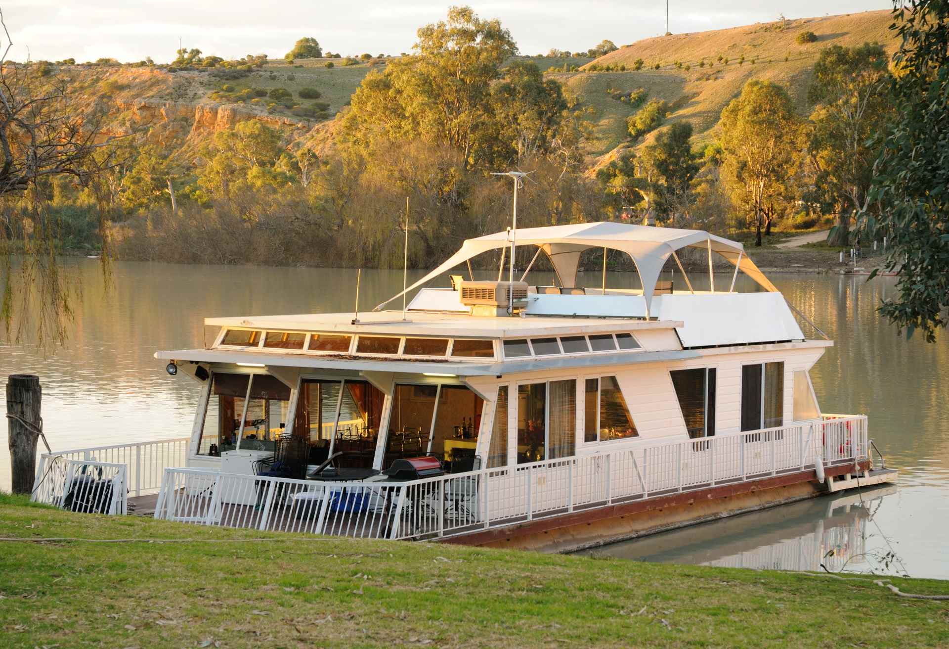 Houseboat at sunset docked on River Murray, South Australia