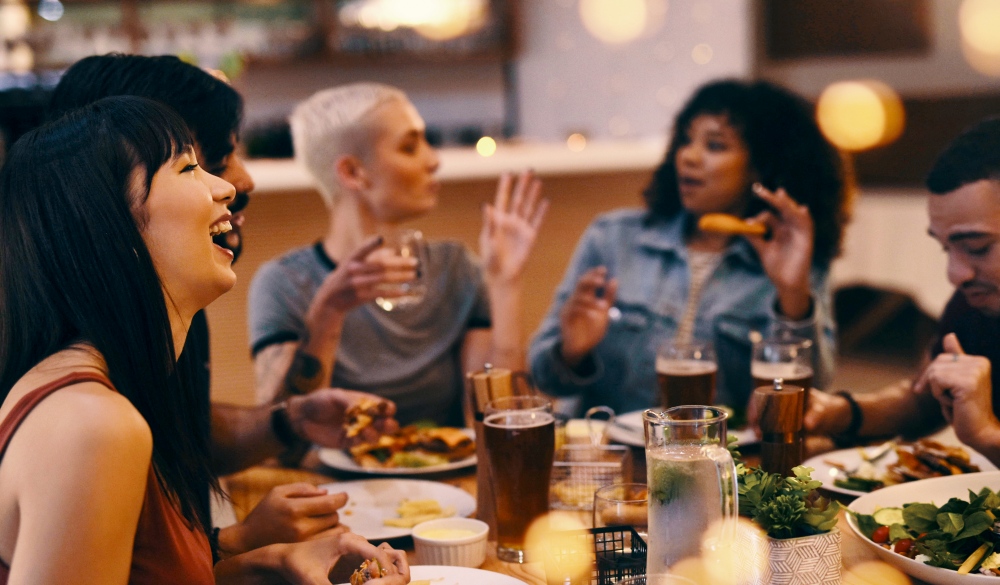 Cropped shot of friends enjoying a meal together at a restaurant