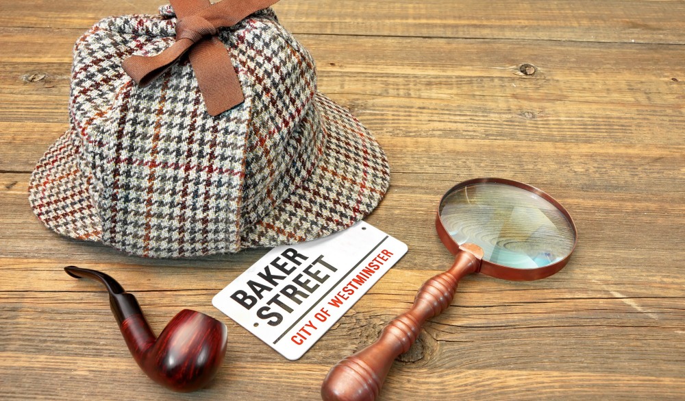 Baker Street Signboard, Sherlock Holmes Cap famous as Deerstalker, Smoking Pipe and Vintage Magnifier on Grunge Wood Table; Shutterstock ID 244276822