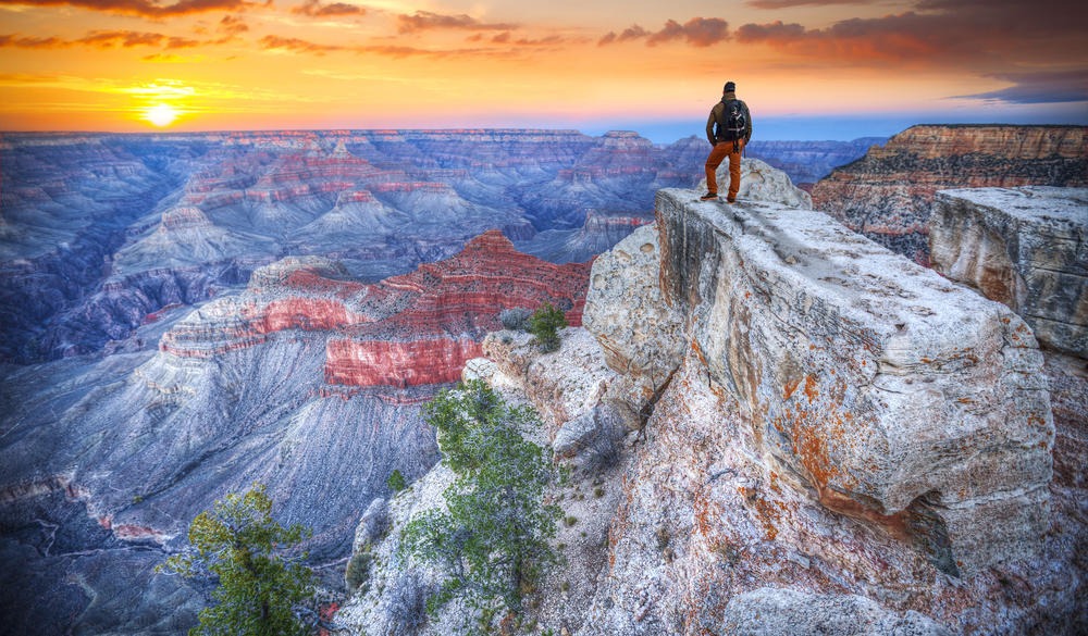 man in the Grand Canyon at sunris