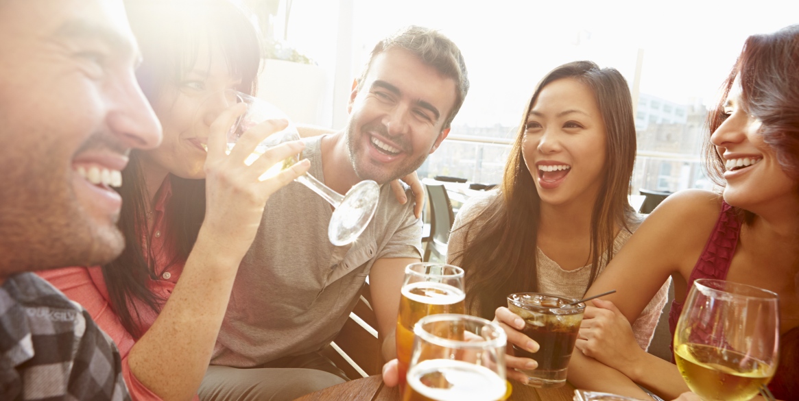 Friends Enjoying Drink At Outdoor Bar