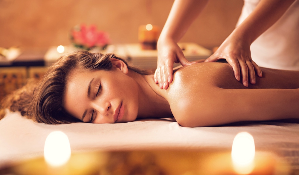 Young woman relaxing during back massage at the spa.