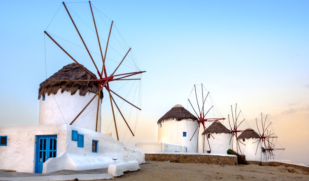 Scenic view of traditional greek windmills on Mykonos island at sunrise, Cyclades, Greece