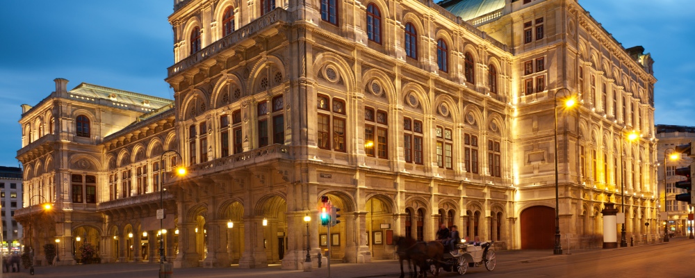 The Opera House in Vienna in the evening right after sunset with the typical Vienna Fiaker (Horse coach) in front. Nikon D3X. Converted from RAW.