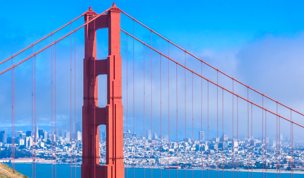 Golden Gate Bridge with the skyline of San Francisco in the background on a beautiful sunny day with blue sky and clouds in summer - Panoramic view from Battery Spencer - San Fancisco Bay Area,  Golden Gate National Recreation Area, California, USA