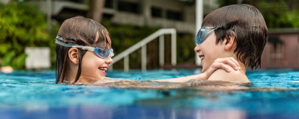 Brother and sister in swimming pool