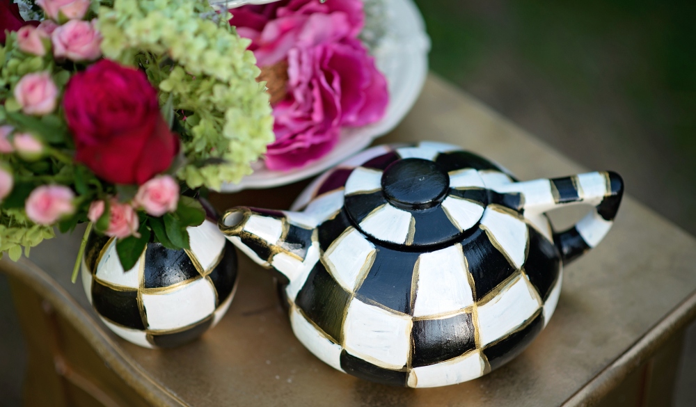 Alice in Wonderland. Scenery for a fairy tale. teapot cups flowers in a vase on a table in a green forest. horizontal; Shutterstock ID 1640772673