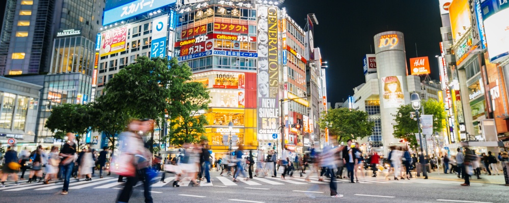 Shibuya crossing with illuminated neon signs at night, Tokyo, Japan