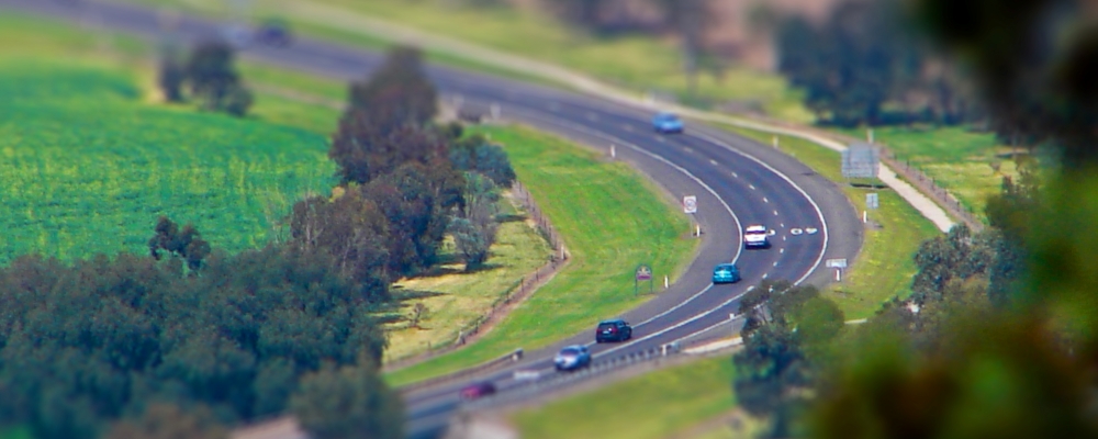 Cars on a country road with miniature effect in Tamworth, NSW, Australia.
