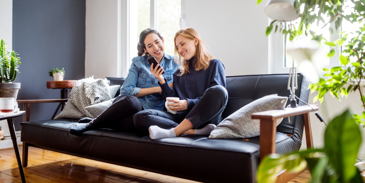 friends sitting together on couch in a living room