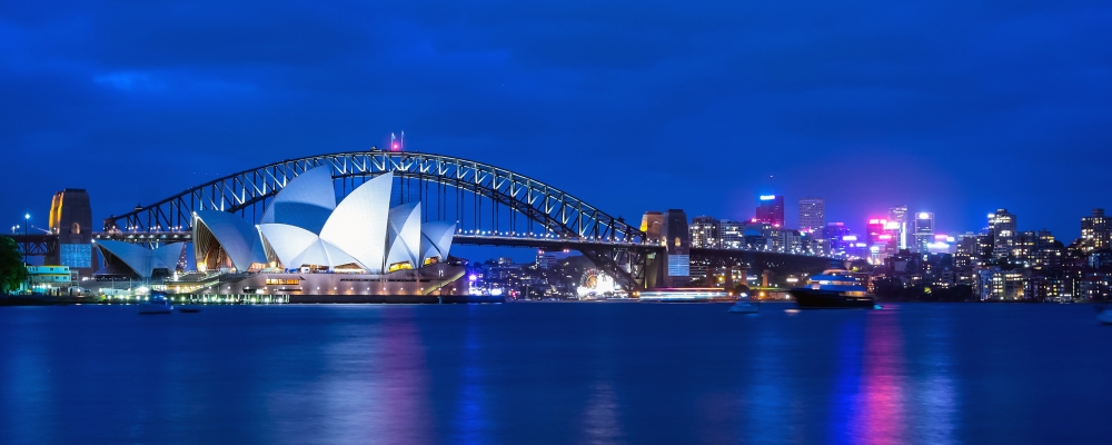 Opera House and Harbor Bridge at twilight view from Mrs. Macquarie's chair viewpoint.