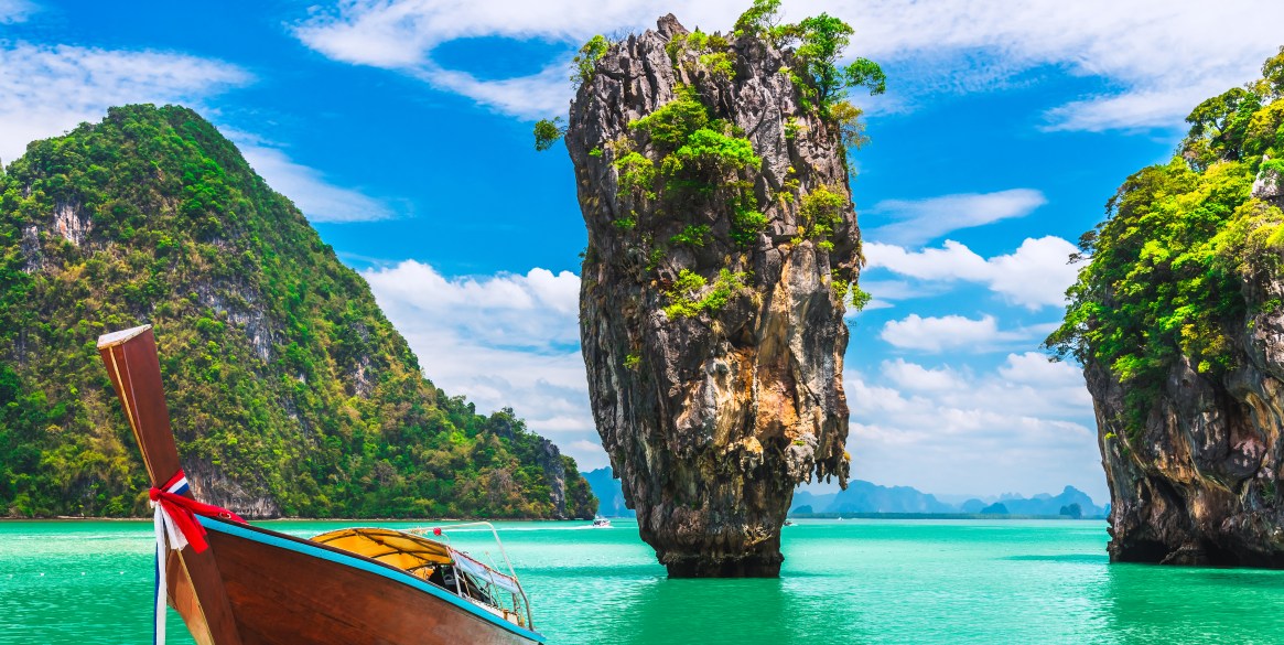 Landscape of amazing James Bond island with longtail boat