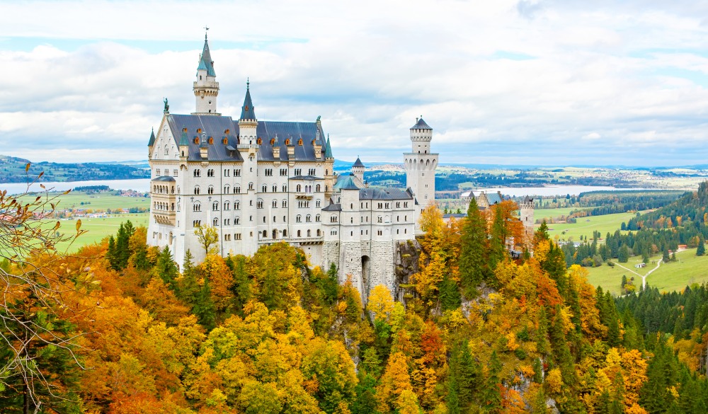 Neuschwanstein Castle, Germany. Image of the famous tourist attraction surrounded with autumn colors during fall