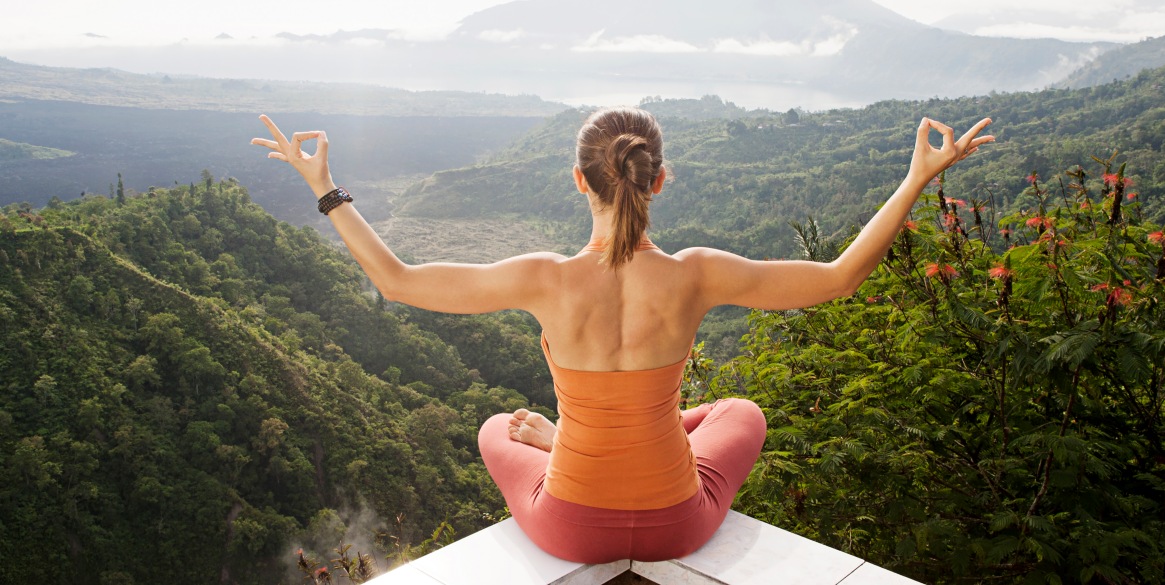 Woman looks out over scenic overlook in Bali, Indonesia.