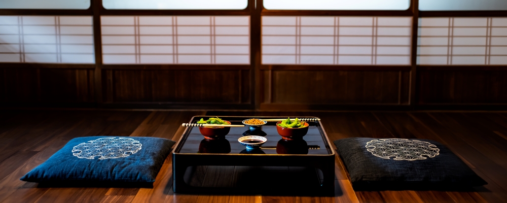 Traditional japanese machiya house or ryokan restaurant with black lacquered wood table and edamame soybeans food with natto and soy sauce