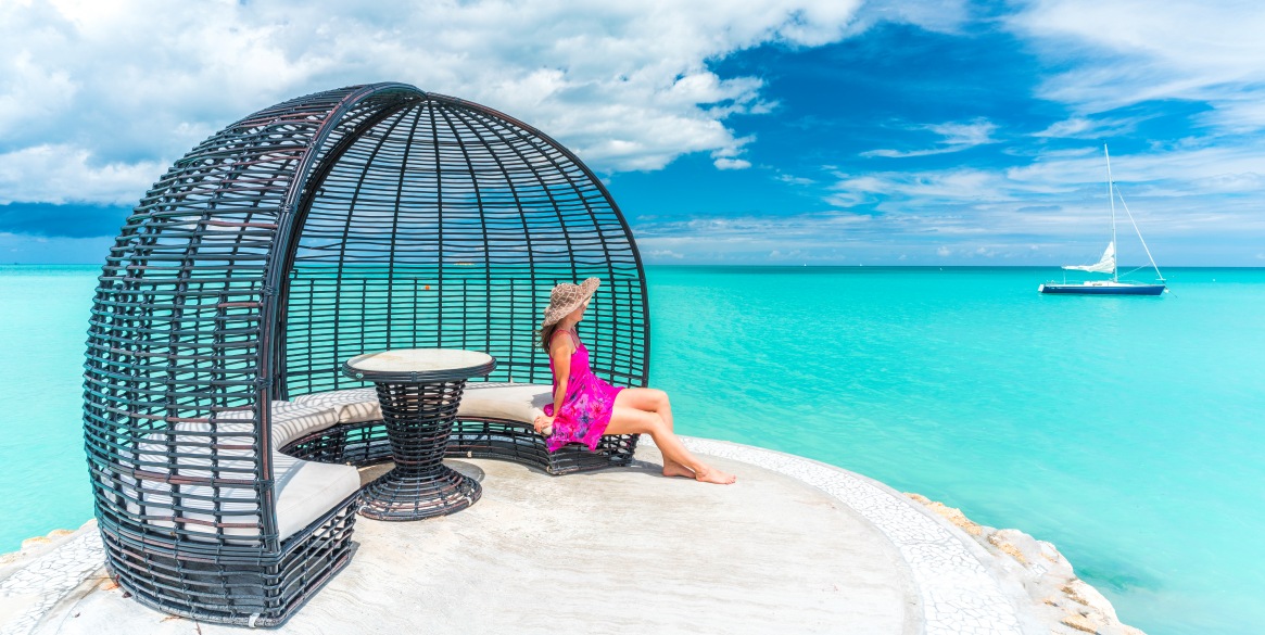 Woman sitting on sofa in a luxury gazebo ad