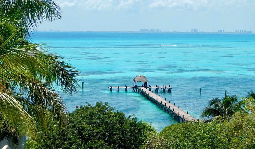 A high angle view from Isla Mujeres, an island in Mexico. looking over the super clear waters of the Caribbean Sea towards the skyline of Cancun.