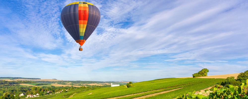 Colorful hot air balloons flying over champagne Vineyards at sunset montagne de Reims, Reims, France