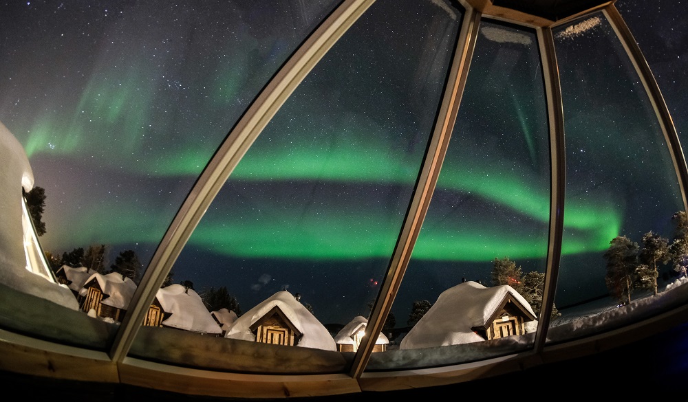 Colorful Aurora Borealis from an igloo hotel