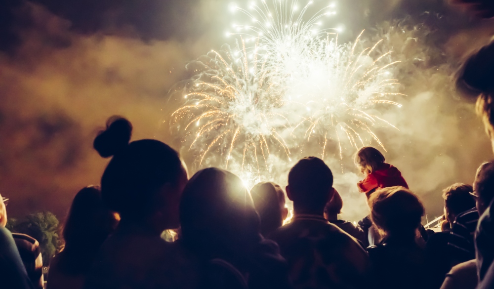 Crowd watching fireworks and celebrating; 