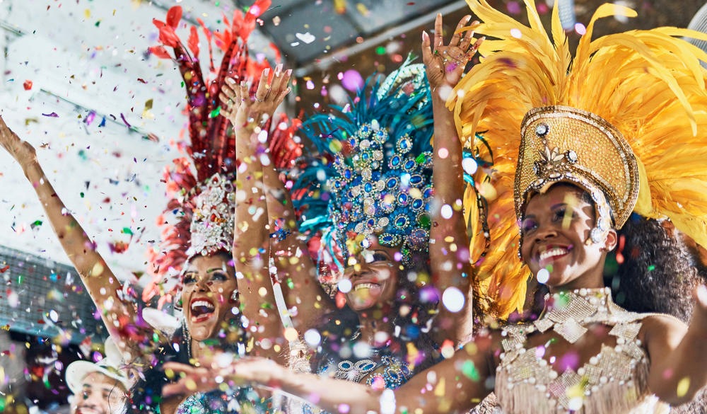 Cropped shot of beautiful samba dancers performing in a carnival with their band