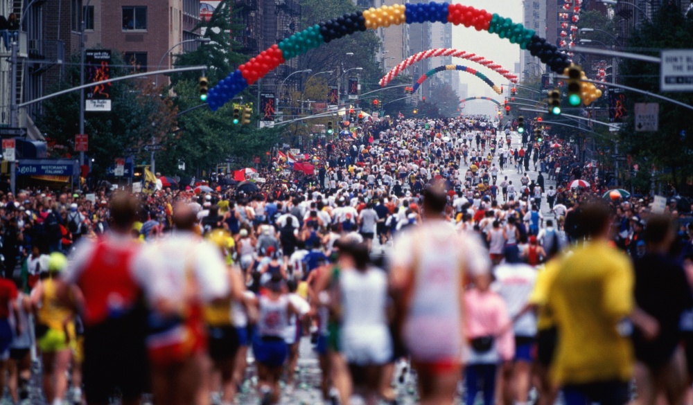 Runners on First Avenue. The New York City Marathon attracts 29,000 runners on a 26.2 mile course that begins on Staten Island at the Verrazano Narrows Toll plaza. It ends in Central Park.