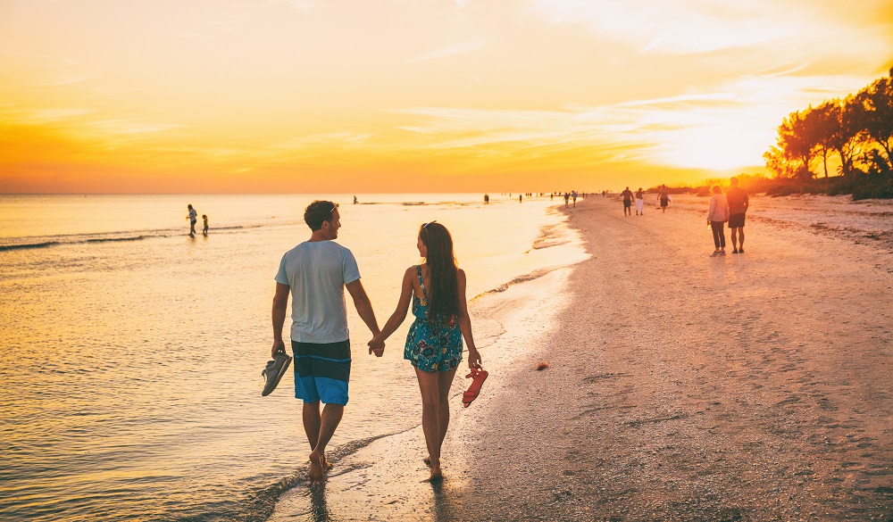 happy couple enjoying sunset walk on Sanibel Island