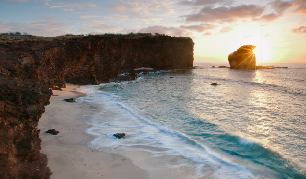 The Hawaiian island of Lanai.  Sweetheart Rock resort beach at Manele Bay, Lanai, Maui, Hawaii, USA. sunrise