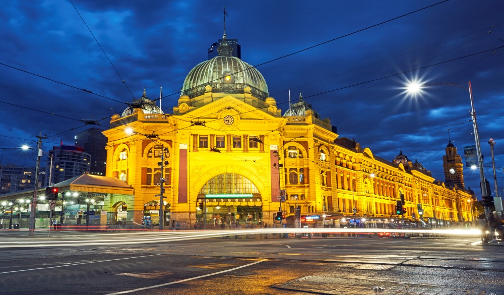 Facade of Flinders street station illuminated at night in Melbourne