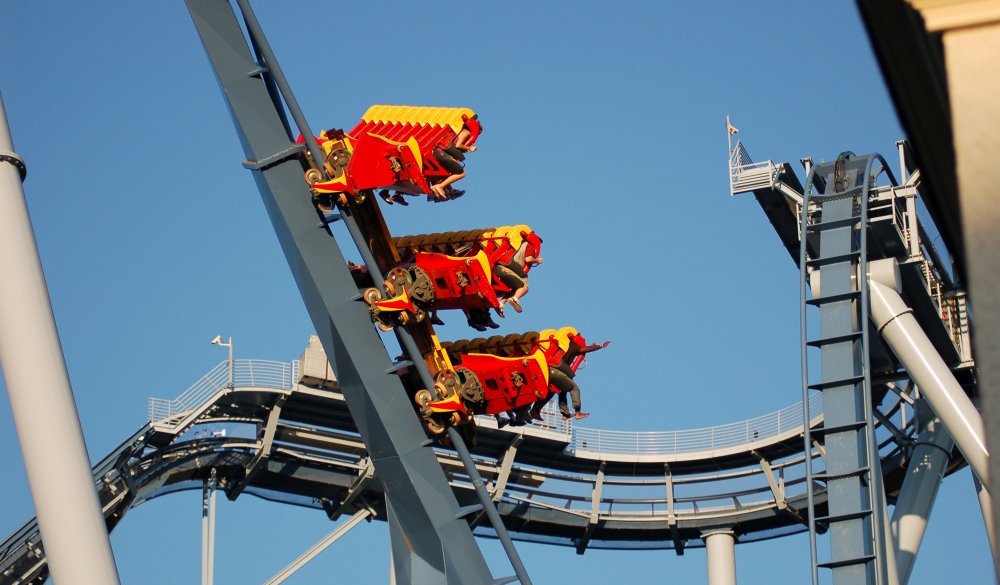 Roller coaster car heading down with the riders feet flying out in front, spring break destinations