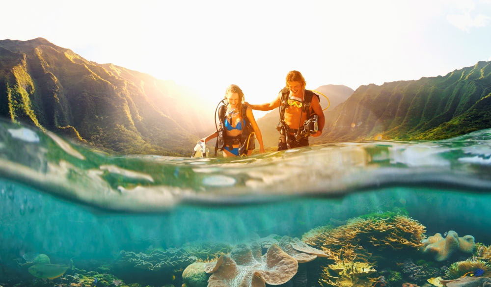 Caucasian couple scuba diving in tropical reef