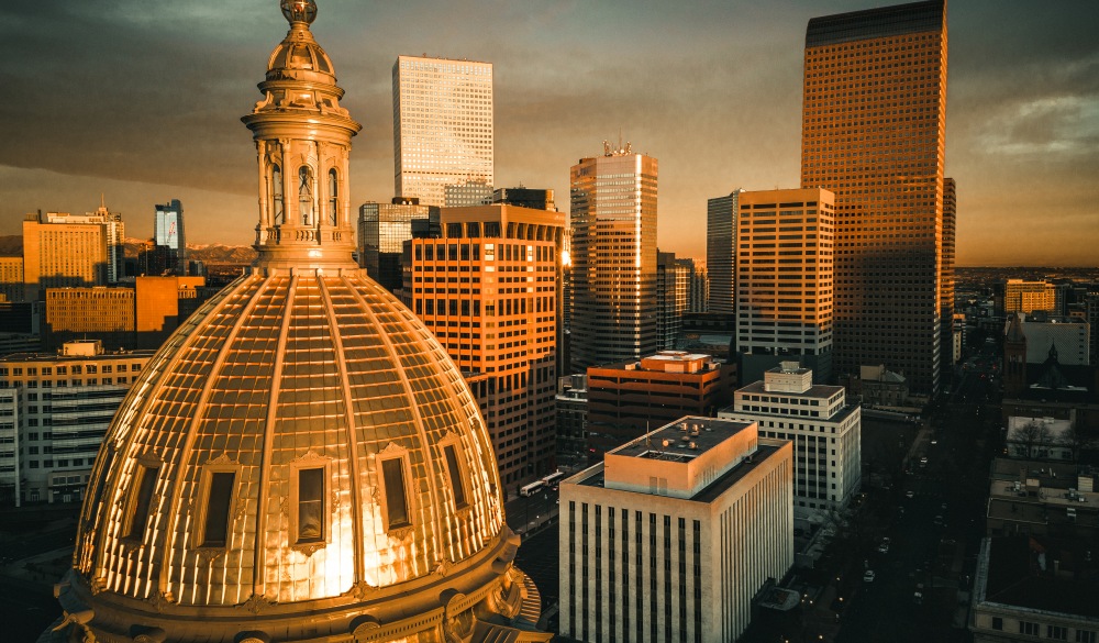 A fiery sunrise over the state capitol building of Colorado.  City of Denver.