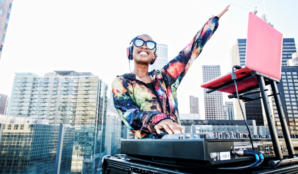 Smiling Black DJ on urban rooftop, cinco de Mayo celebration