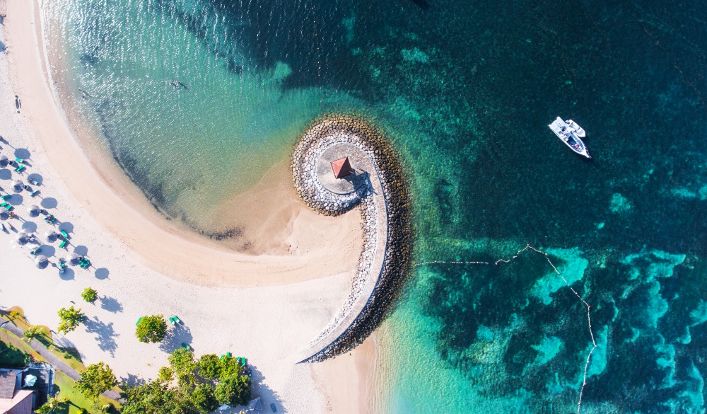 Bali Nusa Dua coast with a figurative breakwater aerial view