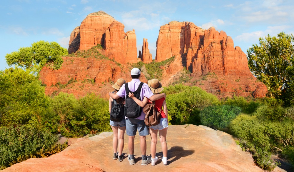 People looking at beautiful mountains landscape. Family on hiking trip enjoying view of  Cathedral Rock, Sedona, Arizona, USA