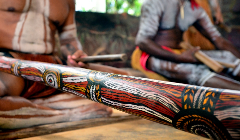 Yirrganydji Aboriginal men play Aboriginal music on didgeridoo and wooden instrument during Aboriginal culture show in Queensland, Australia.; Shutterstock ID 417361339