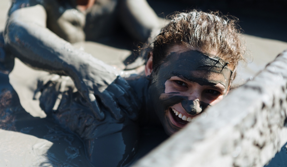 Group of friends swimming in El Totumo mud volcano in Cartagena. natural mud bath