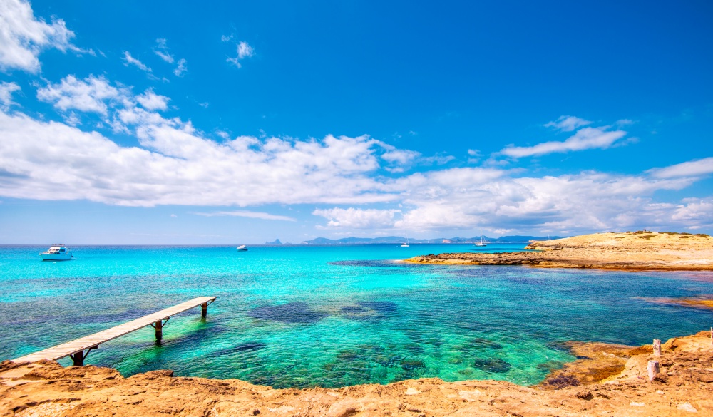 Jetty and private boats at Formentera´s most beautiful and famous beach, Playa de ses Illetes.