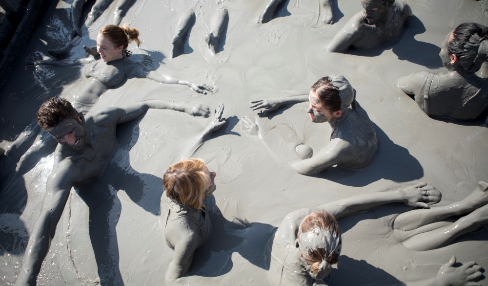  friends swimming in El Totumo mud volcano in Cartagena, natural mud bath