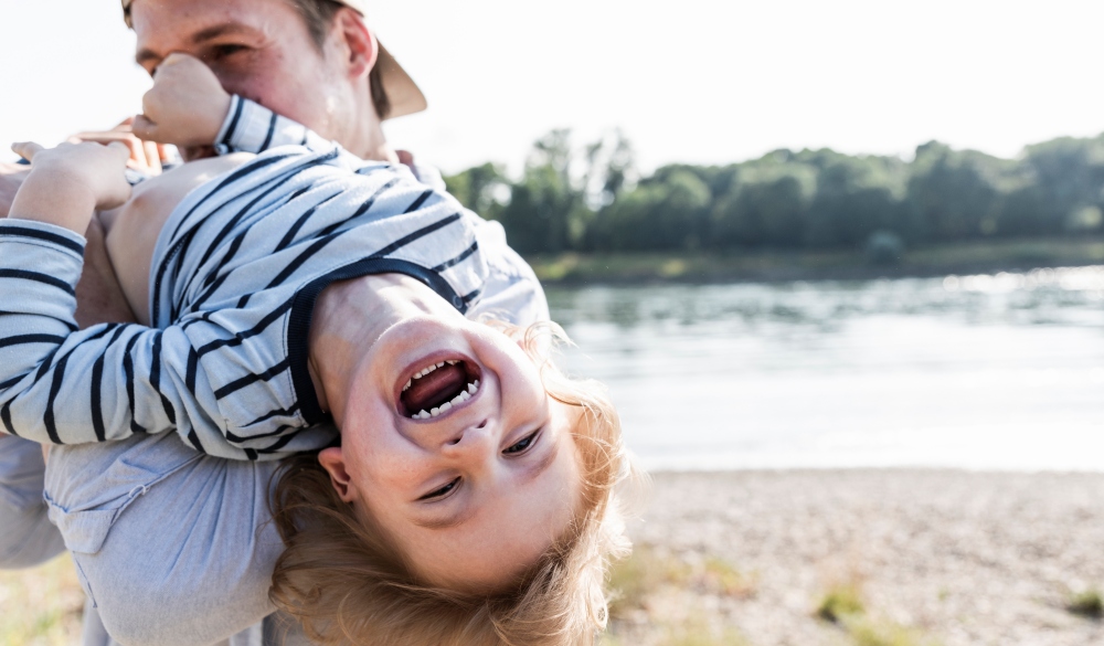 Father and son having fun at the riverside