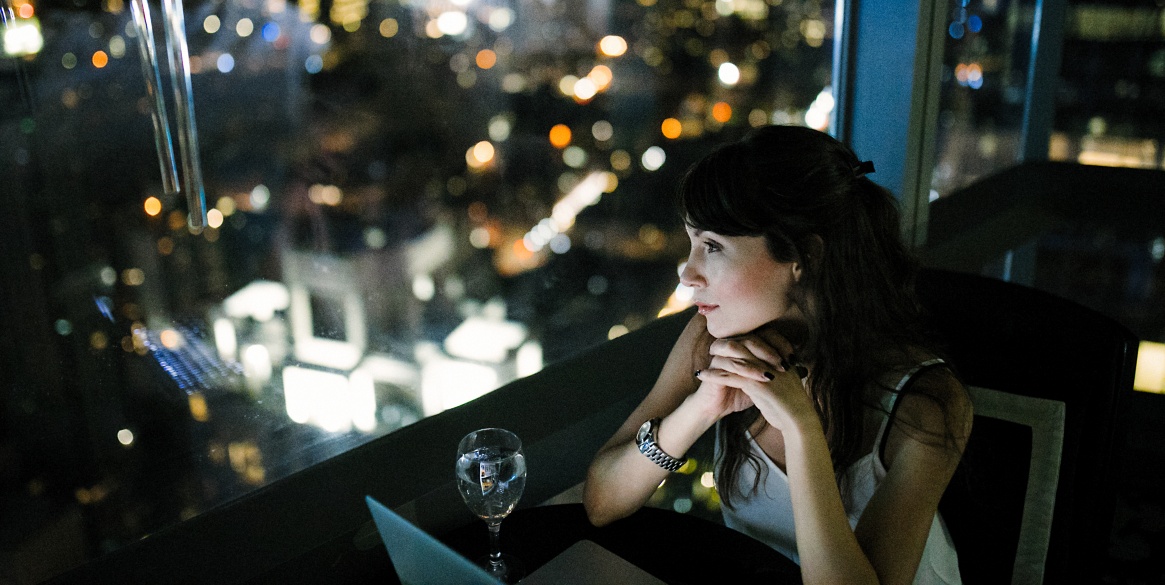 Women sitting by window with city view