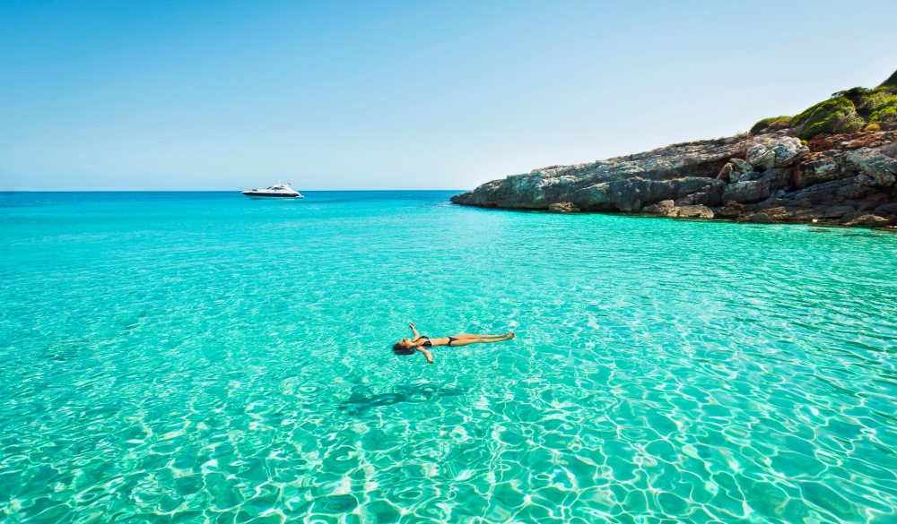 girl floating in fresh clean turquoise water, Tropical Island Vacations