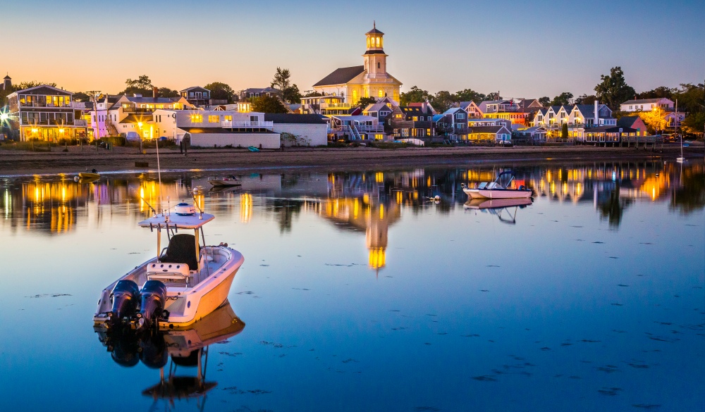 The busy waterfront of charming Provincetown with the glow of blue hour