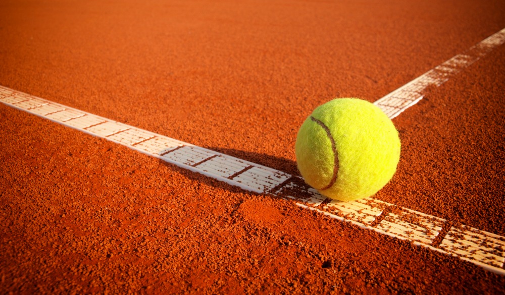 Tennis balls on a tennis clay court