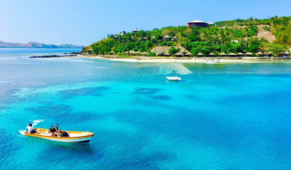 boat floating in Malakati, tropical island vacations