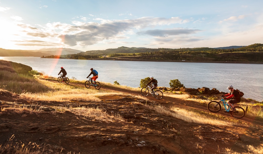 Mountain bikers ride along Columbia River. underrated U.S. destinations