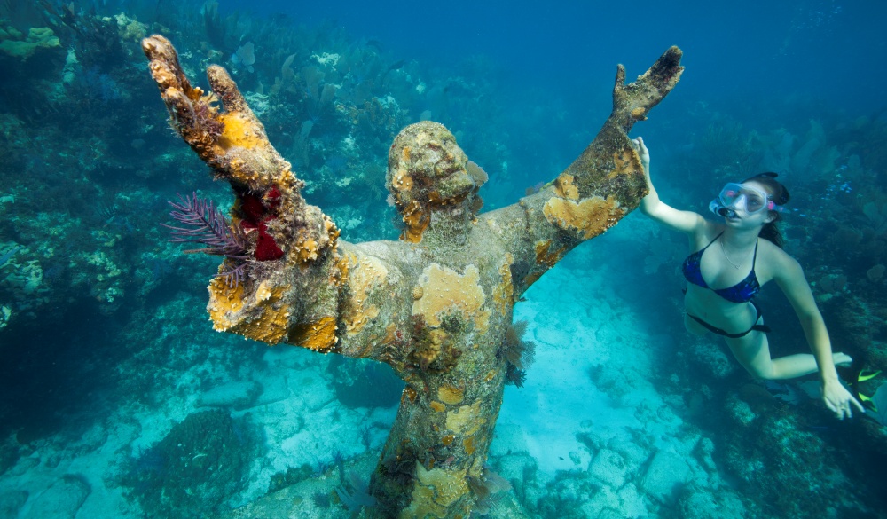 Snorkeler with Bronze Statue of Christ, underrated U.S. destinations